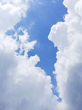 Blue Sky Between White Clouds, Dramatic Cloudscape Background with Bright Daylig Stock Photos