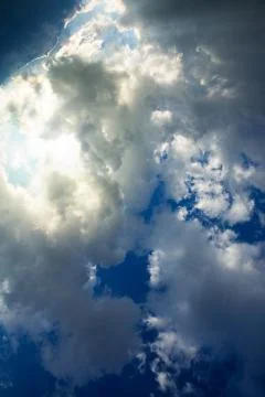 Blue sky with big clouds at sunset. Abstract background. Stock Photos
