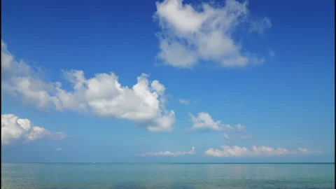 Blue sky with big white clouds over the sea, time lapse Stock Footage 332259821