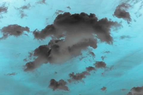 Blue sky with black clouds. toned. Stock Photos