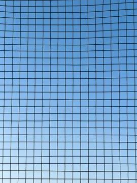 A blue sky with a black grid Stock Photos