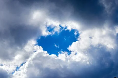 Blue sky breaking through the clouds backgound Foto stock