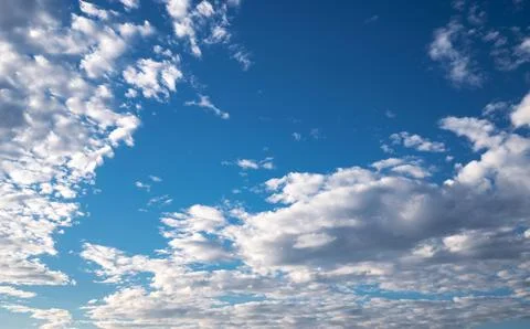 Blue sky with bright clouds background Stock Photos