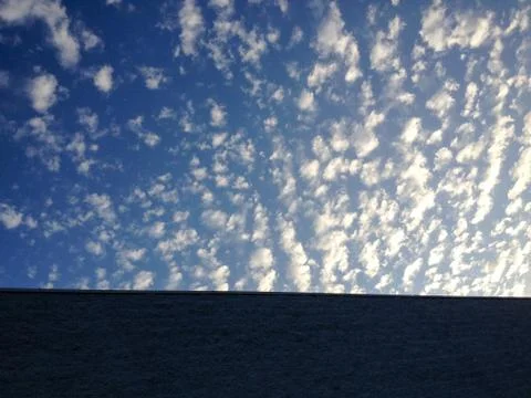 Blue sky cirrocumulus astrocumulus clouds with modern building Stock Photos