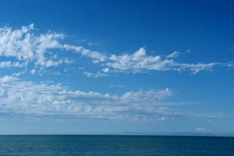 Blue sky with cloud closeup and sea background Stock Photos