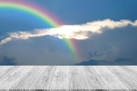 Blue sky cloud with Wood terrace and rainbow Stock Photos