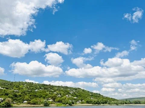 Blue Sky With Clouds Above River and Green Countryside. Stock Photos