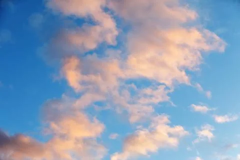 Blue sky with clouds against the background of sunset Stock Photos