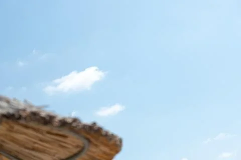 Blue Sky with Clouds and Blurred Thatched Roof Stock Photos