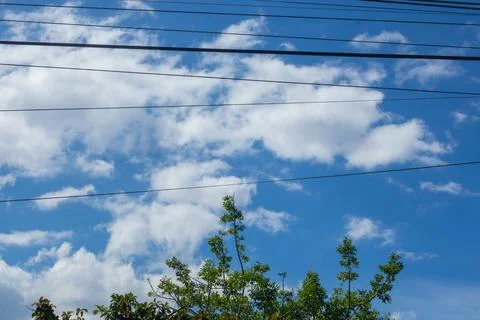 Blue Sky With Clouds and Power Lines Stock Photos
