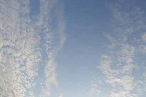 Blue sky with clouds and small bird Stock Photos