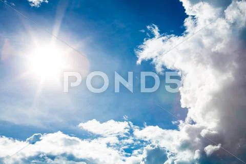 Blue sky with clouds and sun Stock Photos