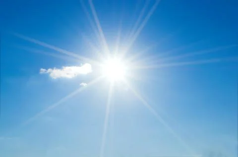 Blue sky with clouds and sun reflection.The sun shines bright in the daytime  Stock Photos