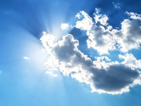 Blue sky with clouds and sun rays. Photos
