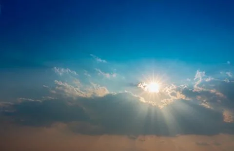 Blue sky with clouds and sun shines Stock Photos