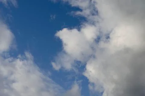 Blue sky with clouds and sun. Stock Photos