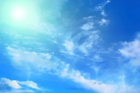 Blue sky with clouds and sunlight Stock Photos