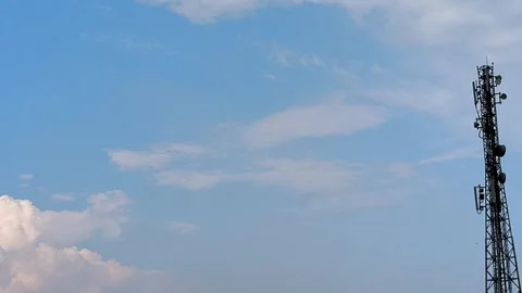 Blue Sky With Clouds and Tall Antenna Mast Against Clear Day Horizon Stock Footage 312104847