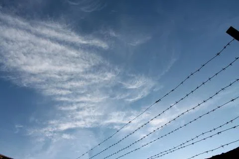 Blue sky with clouds barbed wire Foto stock