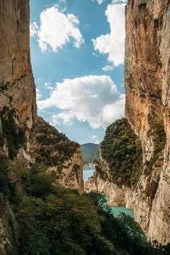 Blue sky with clouds between narrow rocky cliffs. River in Congost de Mont Re Photos