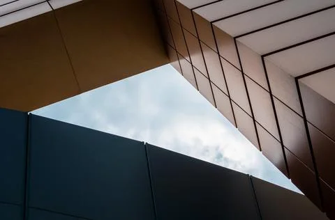 Blue sky with clouds between the walls of a modern office building Stock Photos