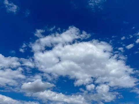 Blue sky with clouds. Bright sun in a blue sky. Sky with copyspace Stock Photos