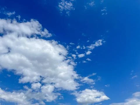 Blue sky with clouds. Bright sun in a blue sky. Sky with copyspace Stock Photos
