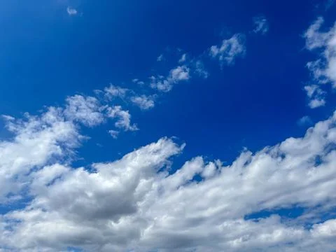 Blue sky with clouds. Bright sun in a blue sky. Sky with copyspace Stock Photos