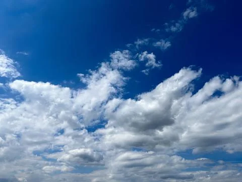 Blue sky with clouds. Bright sun in a blue sky. Sky with copyspace Stock Photos