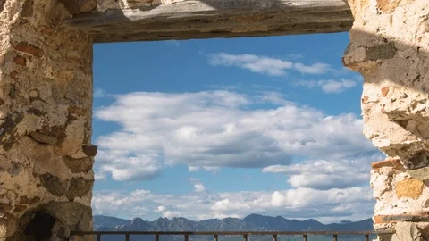 Blue sky clouds framed in window of San Gemiliano watchtower Vidéo 119667309
