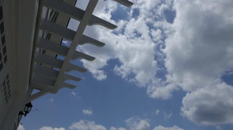 Blue sky clouds, half pergola, static @3400% Stock Footage 25911416