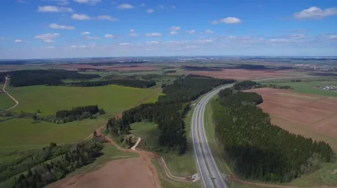 Blue sky with clouds, highway, green forest and fields 스톡 동영상 63571223