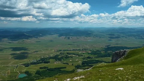 Blue sky with clouds looms over vast green hills. Savin Kuk peak, Montenegro Stock-Footage 342978353