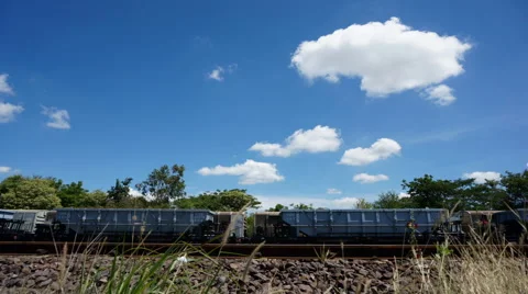 Blue sky clouds moving over train timelapse footage Stock Footage 50152134