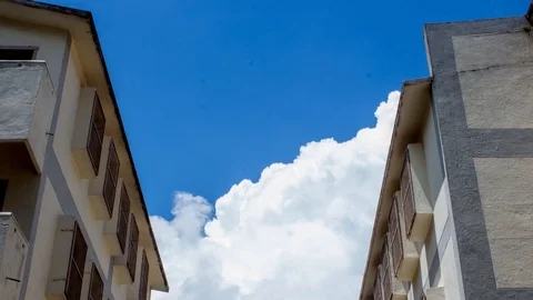 Blue sky clouds moving timelapse back of building Stock Footage 96323324