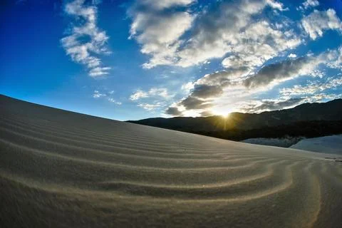Blue sky with clouds over the dunes Stock Photos