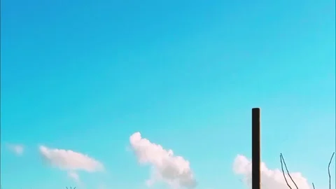 Blue sky with clouds, pole and bare branches Stock Footage 331932425