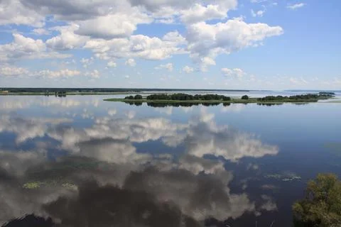 Blue Sky With Clouds Reflected in Calm River Stock Photos