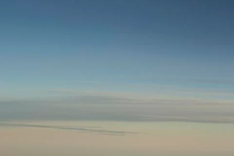 Blue sky with clouds seen from plane window Stock Photos