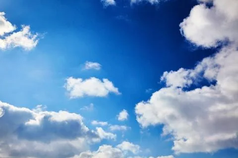 The blue sky with clouds. Spring, winter or summer heaven. Vivid background Stock Photos