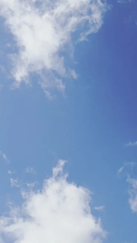 Blue sky with clouds in summer day background. Vertical footage  Stock Footage 339520807