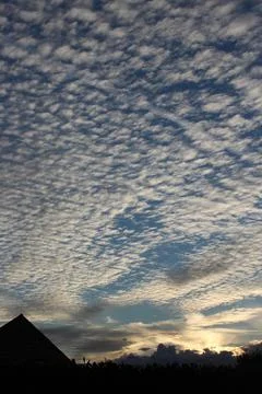Blue sky with clouds at sunset Stock Photos