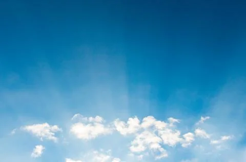 Blue sky cloudscape and white clouds background with sunbreams Stock Photos