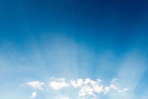 Blue sky cloudscape and white clouds background with sunbreams Foto stock
