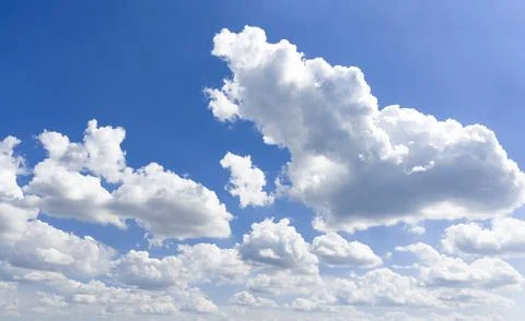 Blue sky with cloudscape clouds. Summer sky holds white clouds. Open sky carries Stockfoto's