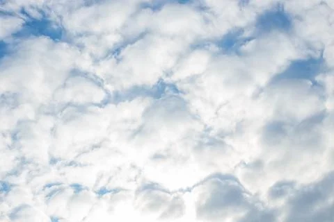 Blue sky with cloudy fluffy feather bed. Celestial atmospheric background Stock Photos