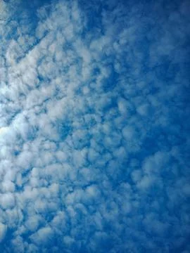 Blue sky with cotton candy clouds Stock Photos