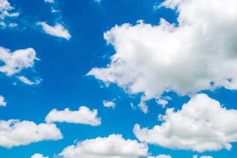 Blue sky with cotton like clouds Stock Photos