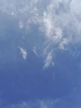 Blue sky covered with a few clouds Stock Photos