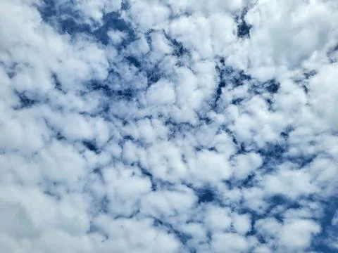 A blue sky covered with small white clouds Photos